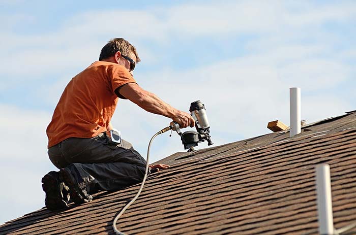 Man repairing roof of the house