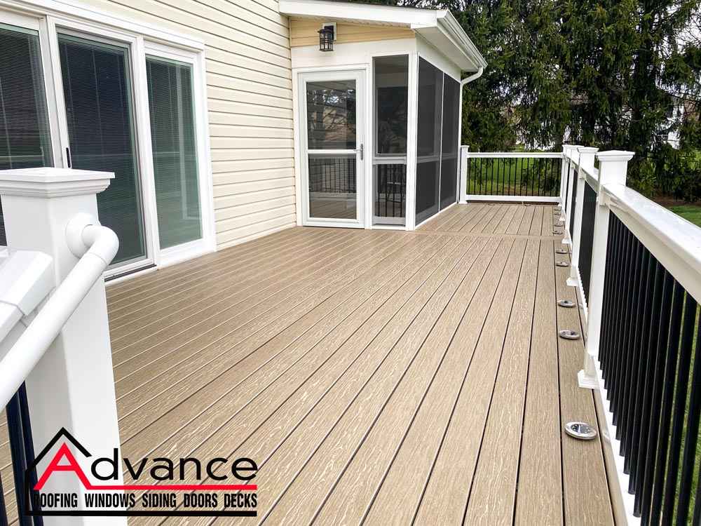 Spacious beige composite deck with white railing after deck replacement in Newark, DE
